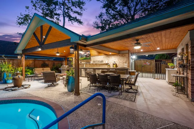 a view of a swimming pool with outdoor seating