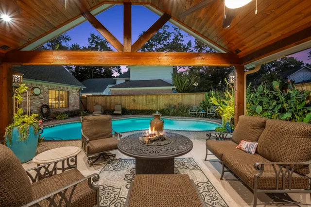 a view of a patio with a dining table and chairs with wooden floor