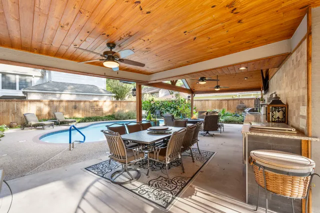 a living room with patio furniture and a potted plant