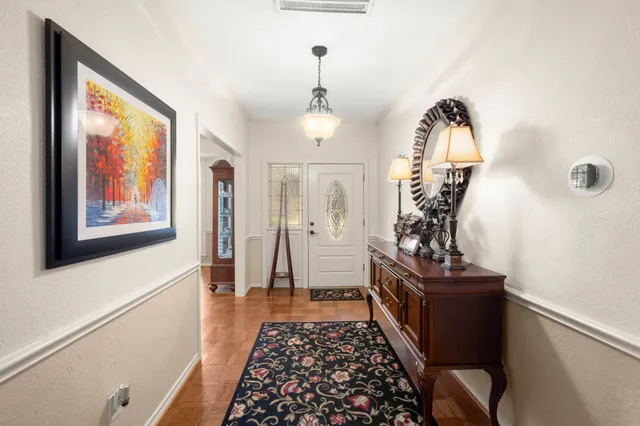 a hallway with a large windows and wooden floor