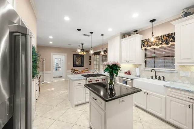 a kitchen with a sink stove and cabinets