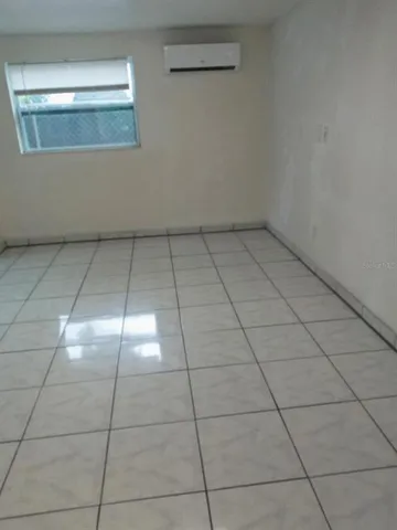 a view of kitchen with a sink cabinets and window