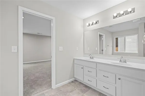 a bathroom with a glass shower door and a glass door