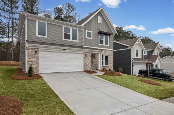 a front view of a house with a yard and garage
