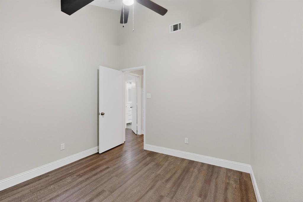 7729 Misty Ridge Drive North Fort Worth, TX 76137 - Photo 23 of 30 an empty room with wooden floor ceiling fan and window