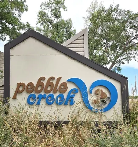 a view of a house with a yard and signage