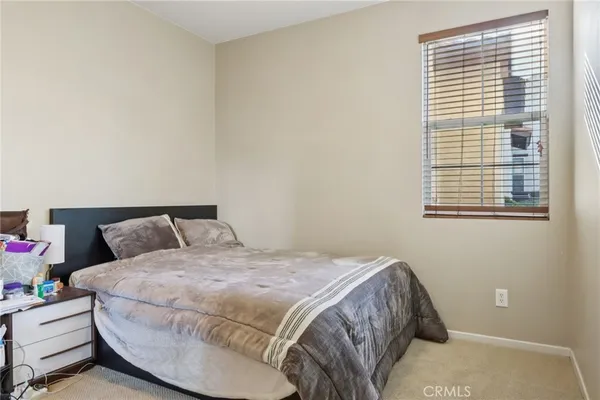 a bed sitting in a bedroom next to a window