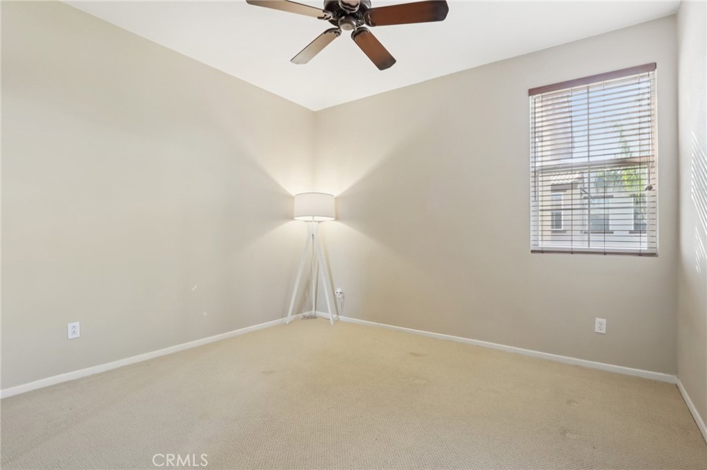3374 Wind Chime Lane Perris, CA 92571 - Photo 16 of 30 an empty room with a window and a ceiling fan