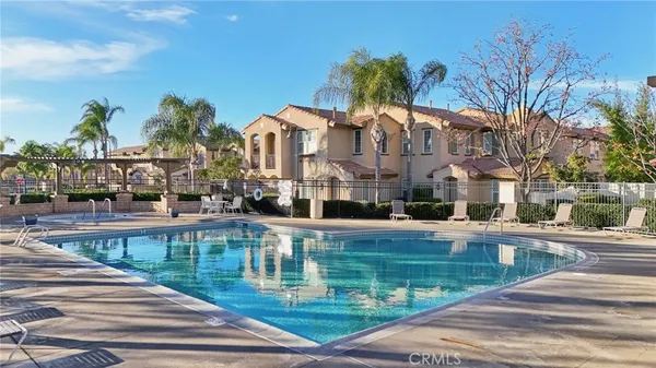 a view of a swimming pool with outdoor seating