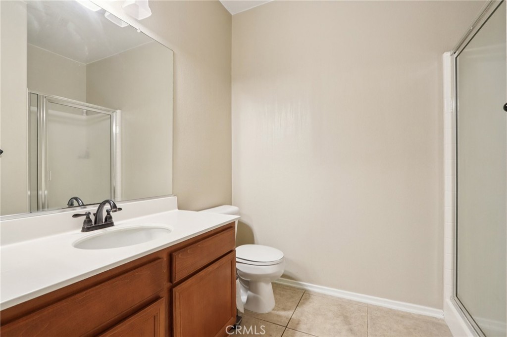 3374 Wind Chime Lane Perris, CA 92571 - Photo 9 of 30 a bathroom with a sink a toilet and mirror