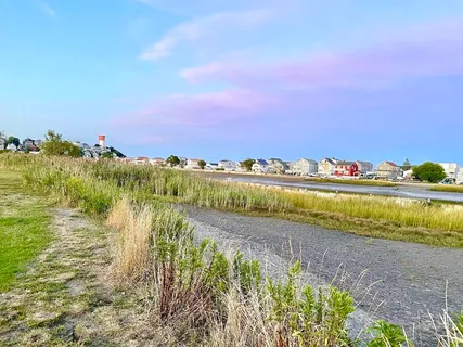 a kitchen with stainless steel appliances granite countertop a refrigerator a sink a stove and oven