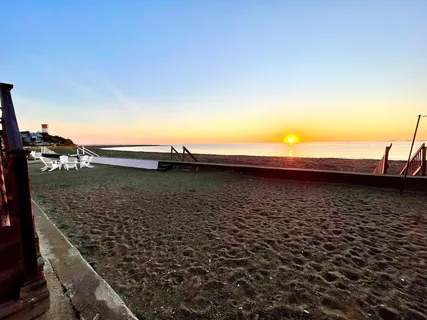 a view of a kitchen with kitchen island a sink wooden floor and a counter top space