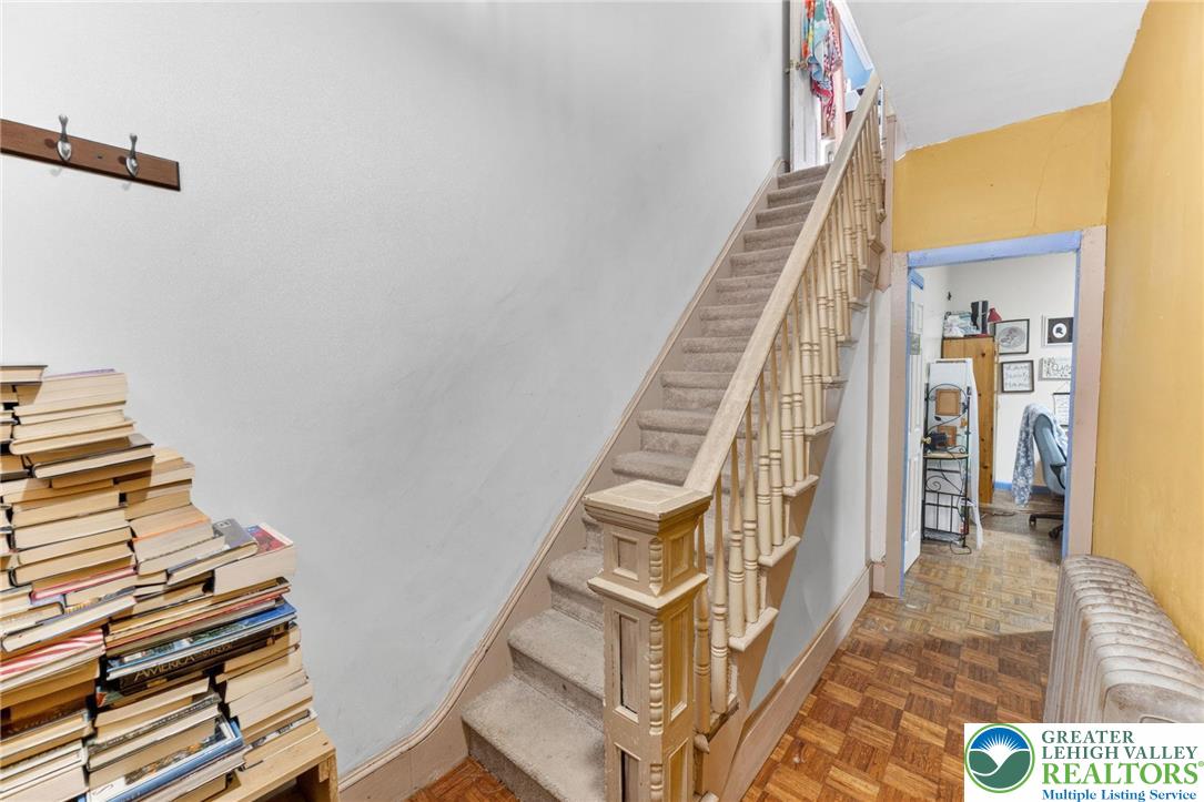 321 Market Street Bangor, PA 18013 - Photo 8 of 33 a view of staircase with lots of frames on wall and a chandelier