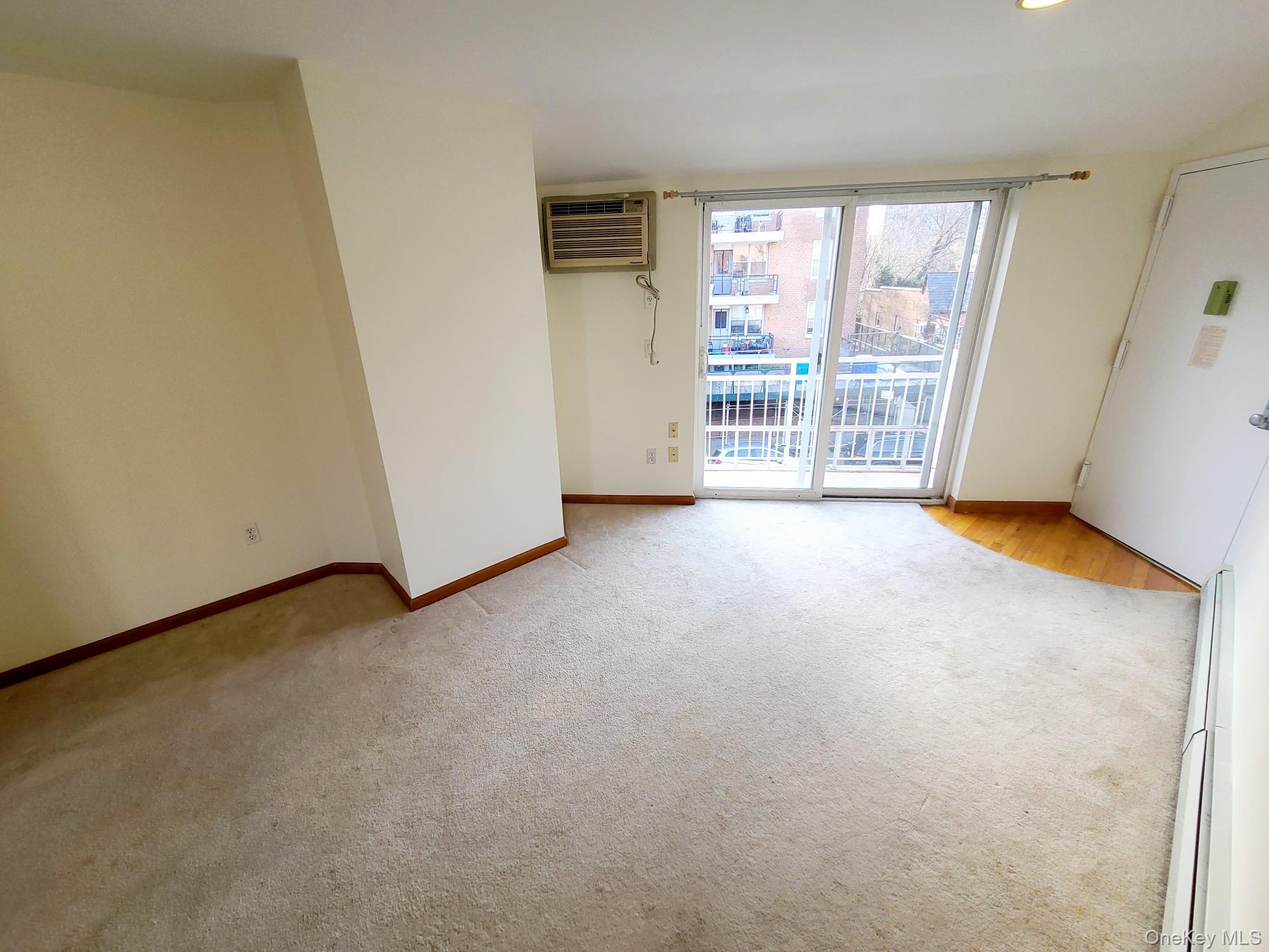 67-08 Exeter Street, Unit 3 Queens, NY 11375 - Photo 2 of 18 an empty room with windows