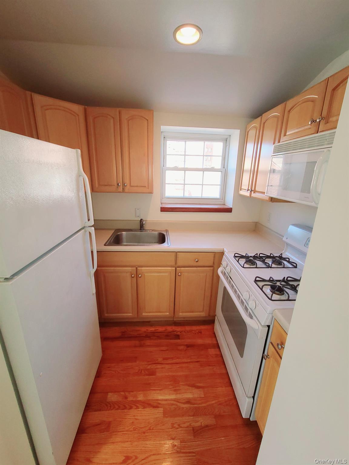 67-08 Exeter Street, Unit 3 Queens, NY 11375 - Photo 7 of 18 a kitchen with a white stove top oven and refrigerator