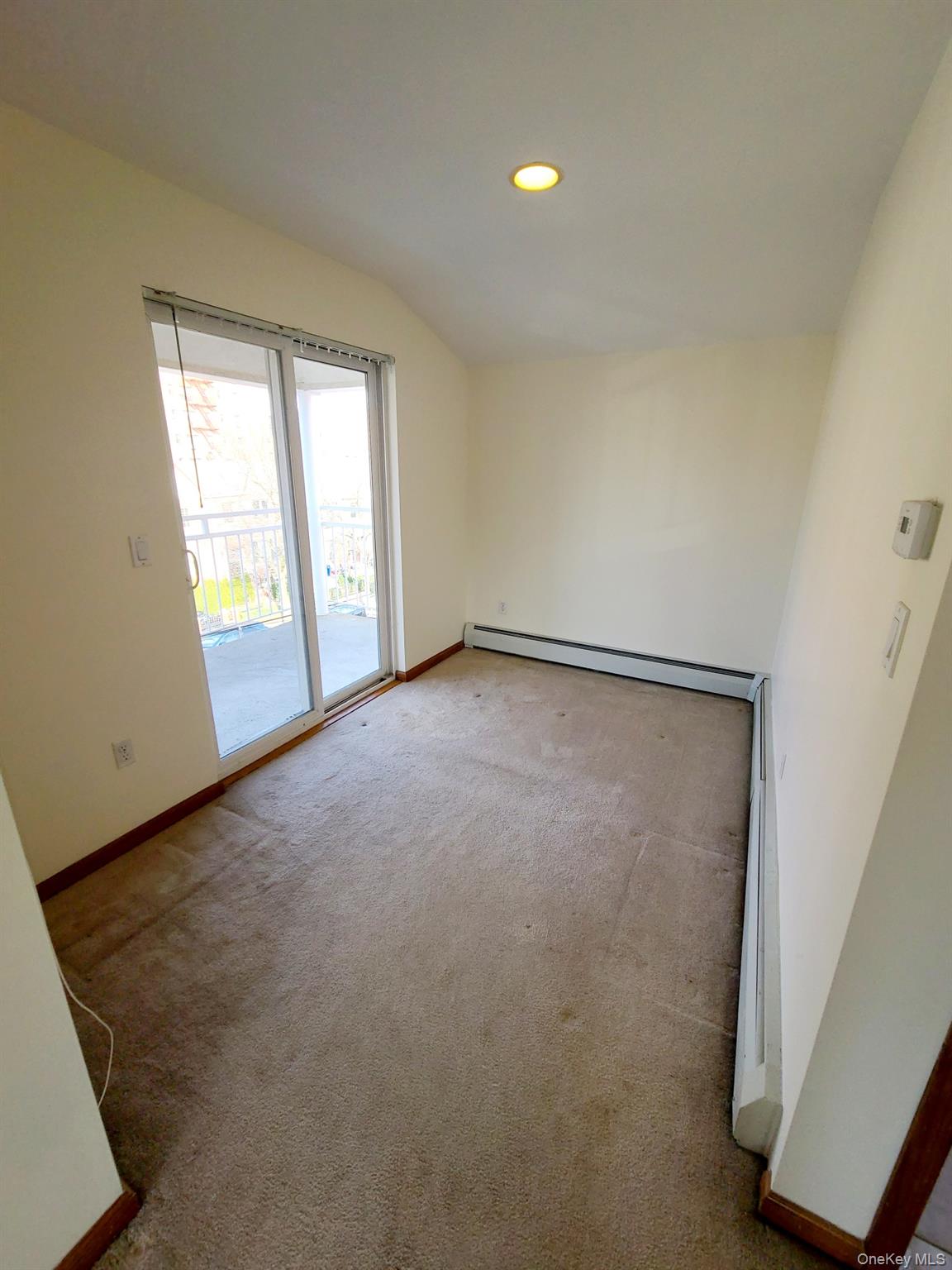 67-08 Exeter Street, Unit 3 Queens, NY 11375 - Photo 9 of 18 an empty room with windows and closet