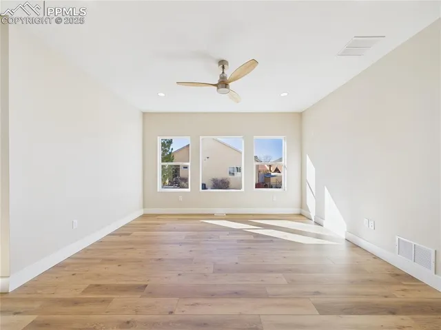 a view of a livingroom with a window and a ceiling fan