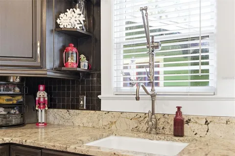 a kitchen with lots of counter top space and refrigerator