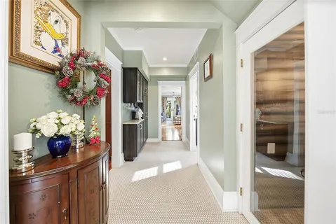 a front view of a dining room with furniture and flowers