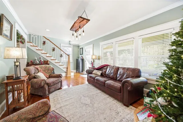 a living room with furniture a fireplace and a floor to ceiling window