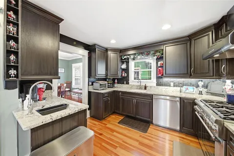 a kitchen with stainless steel appliances granite countertop a sink stove and refrigerator