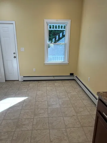 a view of a room with wooden floor and white walls