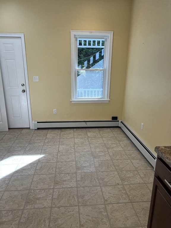 15 Maple Avenue, Unit 1 Bridgewater, MA 02324 - Photo 3 of 8 a view of a room with wooden floor and white walls