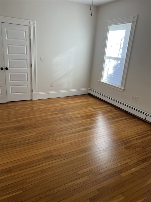 15 Maple Avenue, Unit 1 Bridgewater, MA 02324 - Photo 4 of 8 an empty room with wooden floor and windows