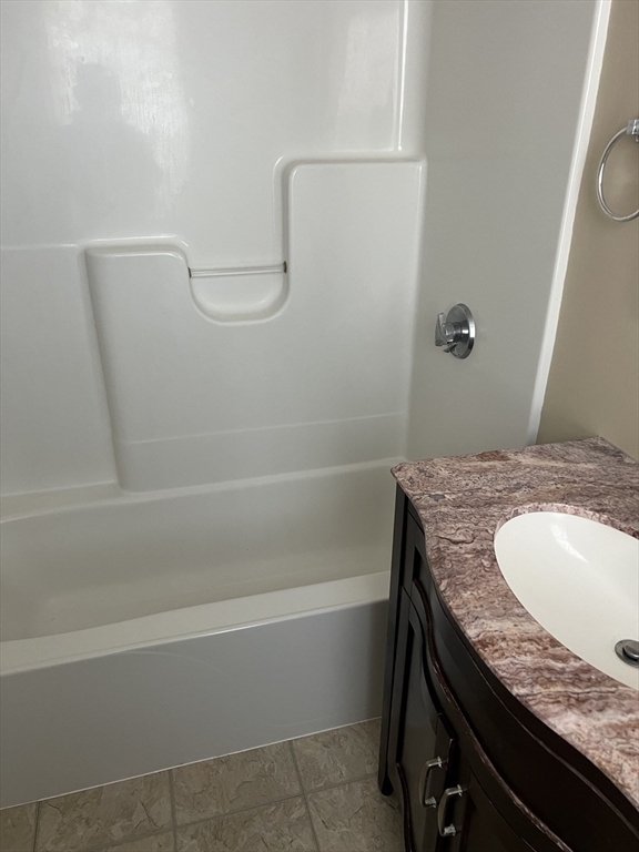 15 Maple Avenue, Unit 1 Bridgewater, MA 02324 - Photo 5 of 8 a bathroom with a granite countertop sink a toilet and shower