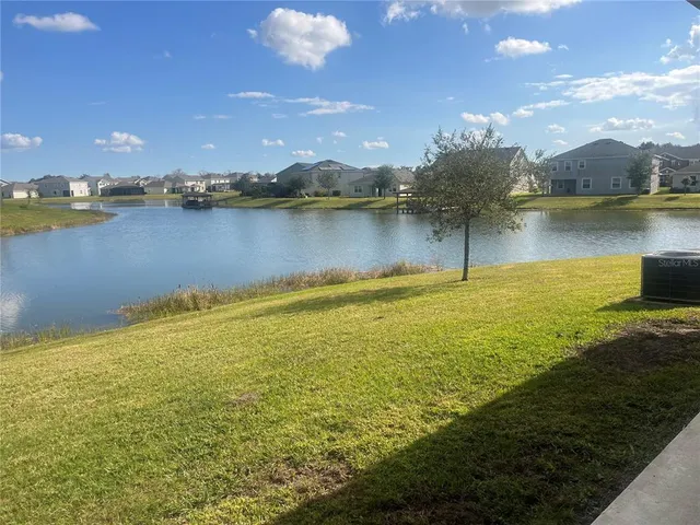 a view of a lake with houses in the back
