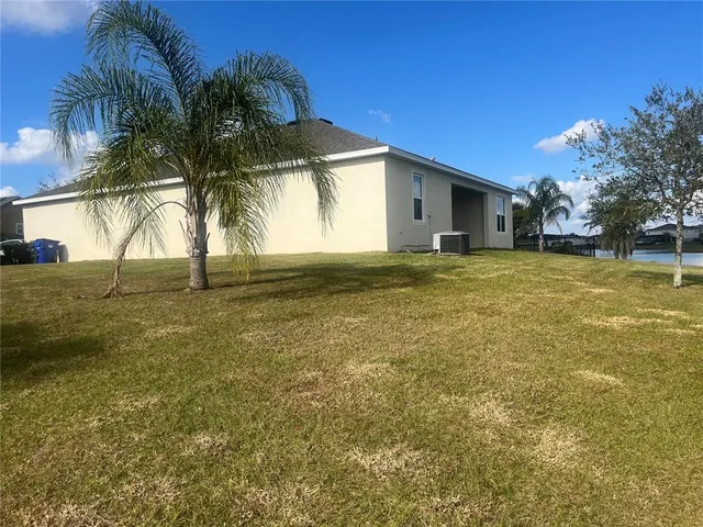 a view of beach and small yard