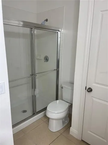 a bathroom that has a toilet and a shower