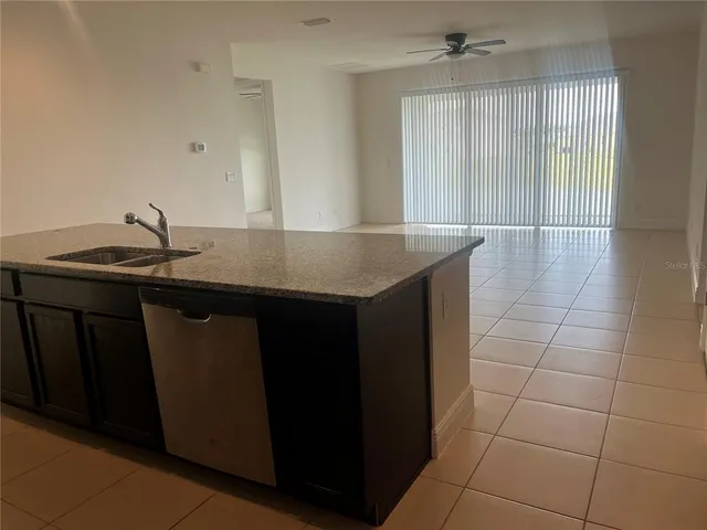 a kitchen with a sink a counter space and a window