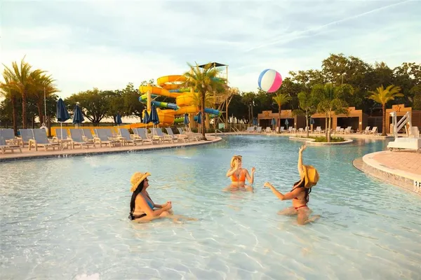 swimming pool view with a seating space
