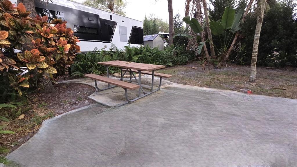 231 Stallion Lane River Ranch, FL 33867 - Photo 4 of 18 a view of a chairs and table in the backyard