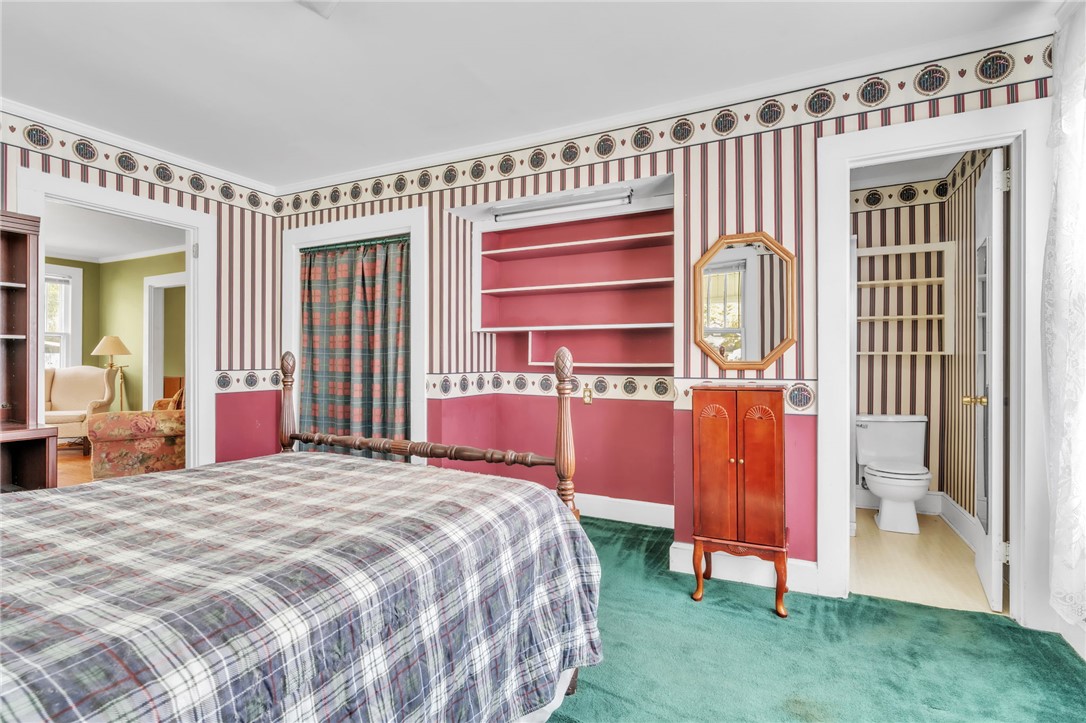 121 Ellison Street Belton, SC 29627 - Photo 14 of 30 This cozy bedroom features plush carpeting and an adjacent bathroom, perfect for comfort and privacy.