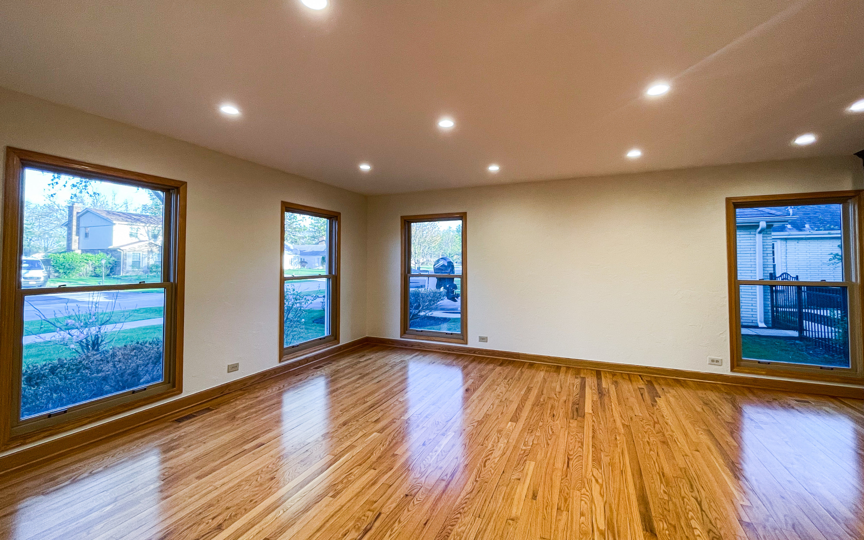 1640 Barry Lane Glenview, IL 60025 - Photo 7 of 42 a view of an empty room with wooden floor and windows