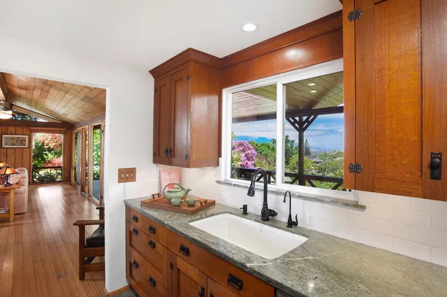 a kitchen with stainless steel appliances granite countertop cabinets and wooden floor