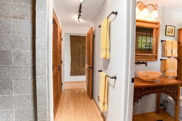 a bathroom with a sink a toilet a shower and a mirror