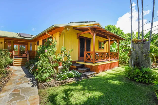 a front view of a house with garden