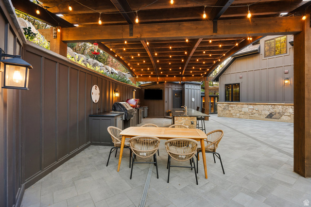 1141 South Oak Leaf Lane Springville, UT 84663 - Photo 121 of 147 Expansive outdoor patio featuring a wooden pergola with string lighting, board and batten wall, paved flooring, and a built-in outdoor kitchen with a grill and sink