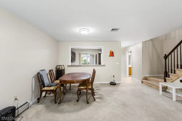 a view of a livingroom with furniture and a window