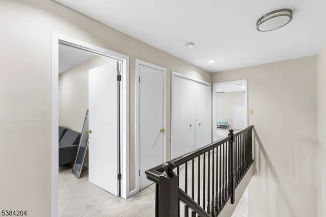 a view of a hallway with closet and a fireplace