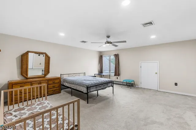 a bedroom with furniture and a window