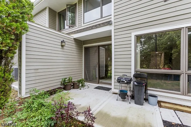 a view of a chair and table in backyard of the house