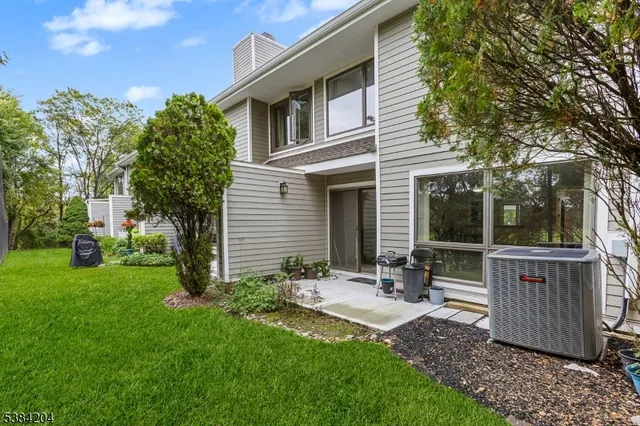 a view of a patio with table and chairs with wooden fence and plants