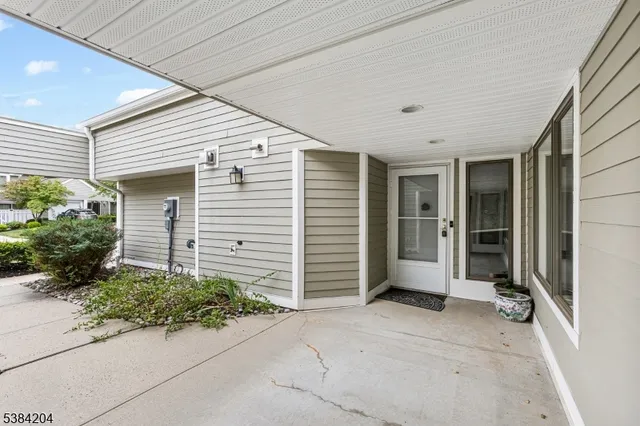 a view of house with entryway door and outdoor seating