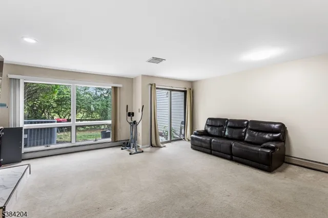 a living room with furniture and large windows