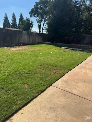 a view of a swimming pool with a yard