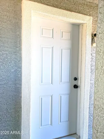 a living room with furniture a rug and a window